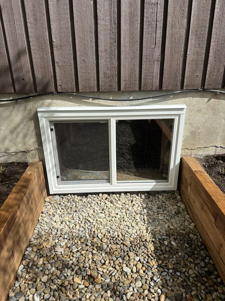 Custom cedar wood window well — close-up exterior view Calgary