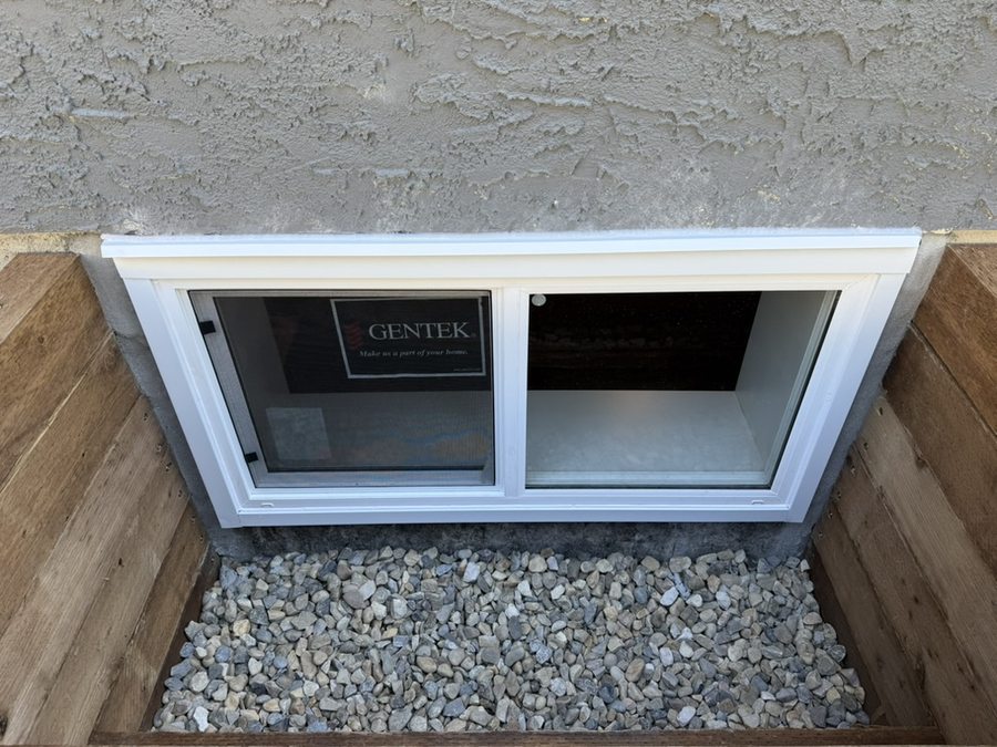 Finished cedar and PT wood window well with egress slider Calgary