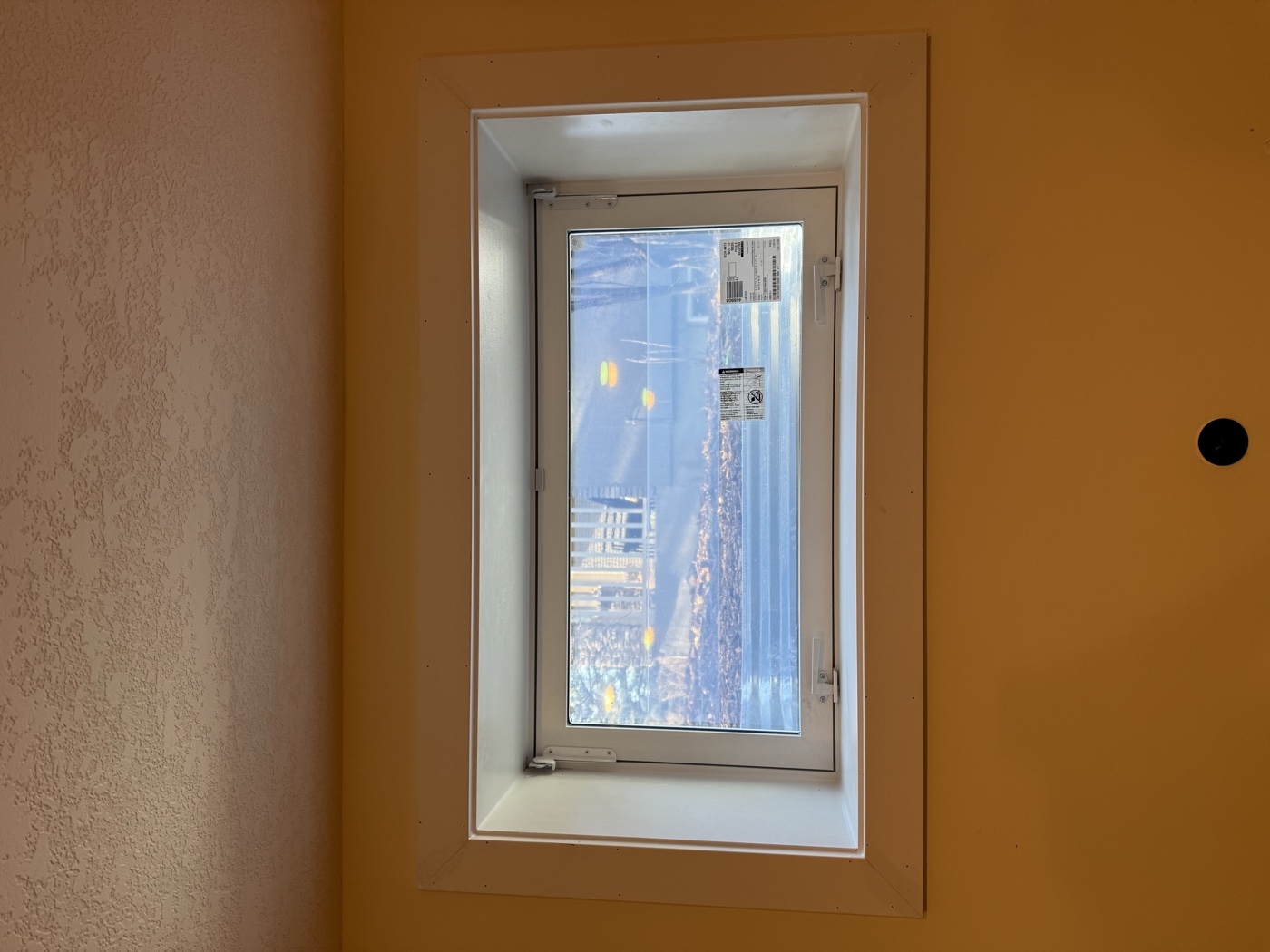Interior egress window with white melamine finishing — Calgary legal suite bedroom