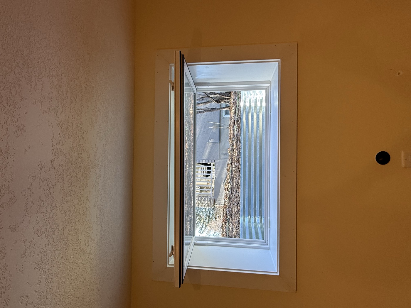 Interior finished hopper egress window — inward swinging style, Calgary basement