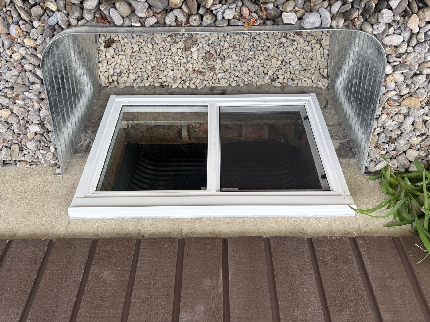 Finished egress window and galvanized well — Calgary exterior