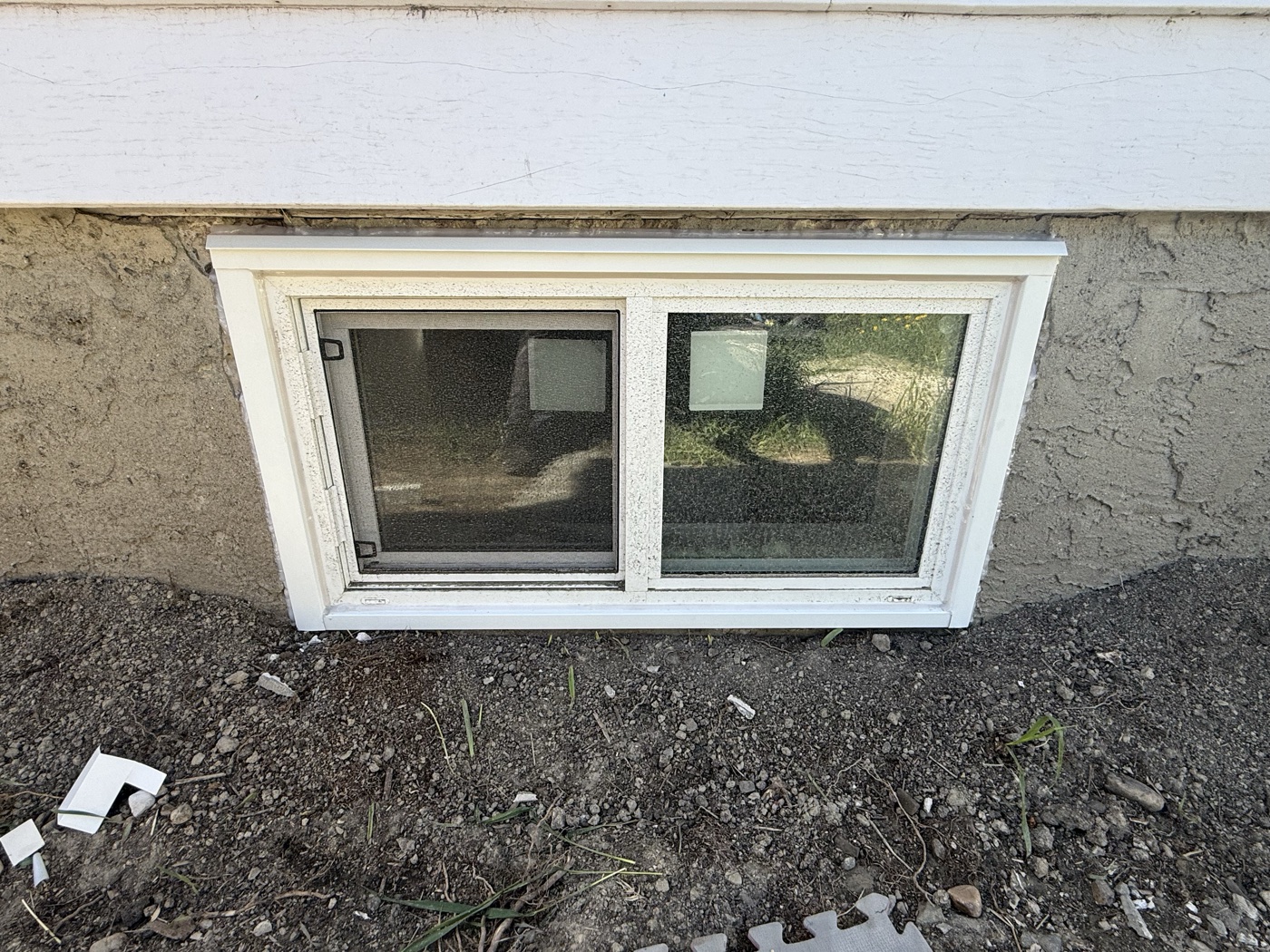Egress window installation finished exterior — Calgary home upgrade