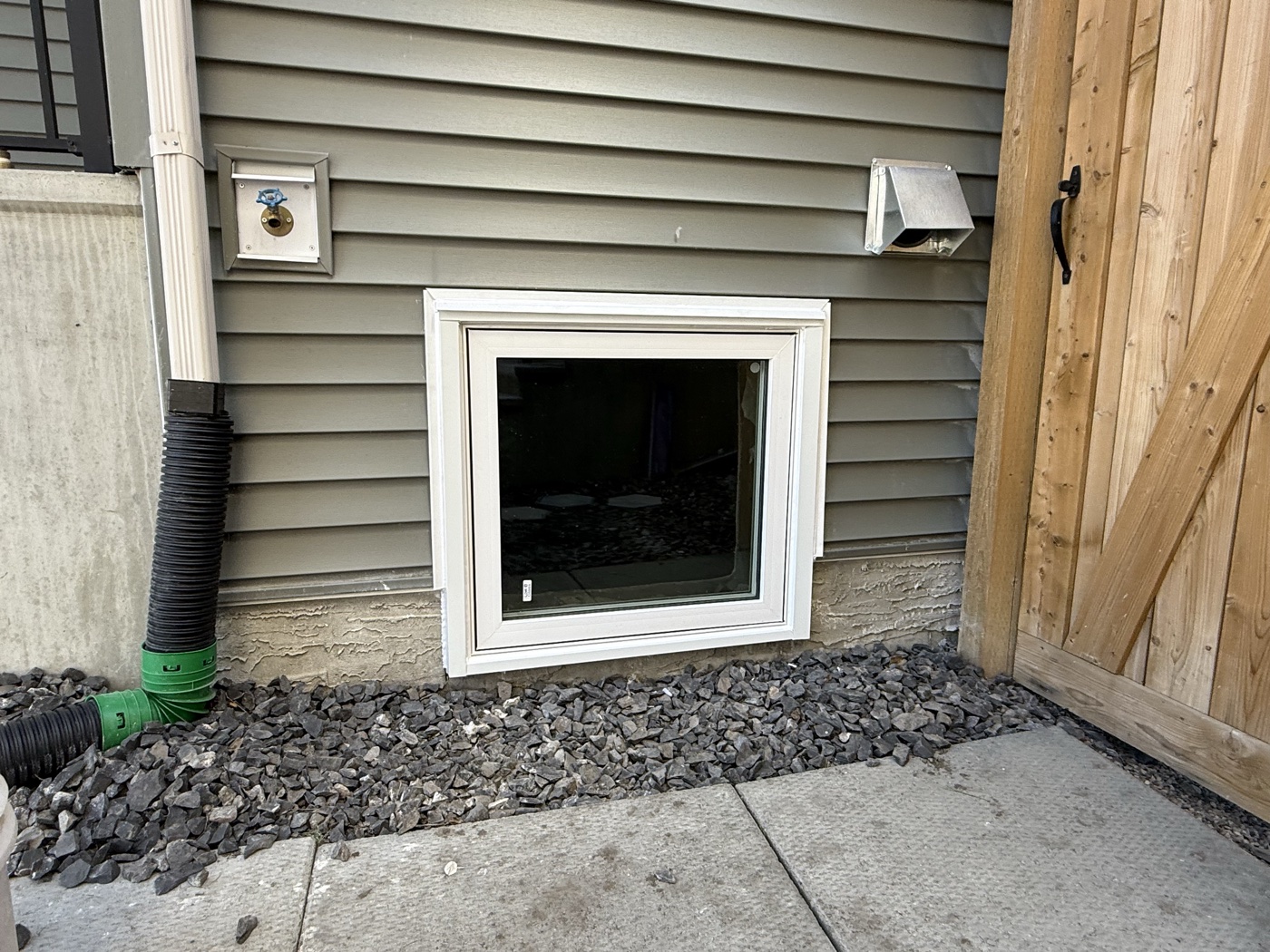 Egress casement window installed in Calgary basement — outward swinging style