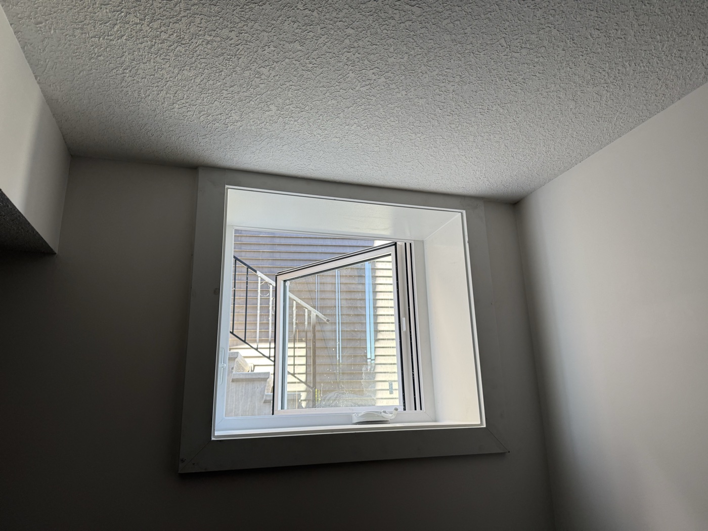 Interior egress window casement finishing — Calgary legal suite