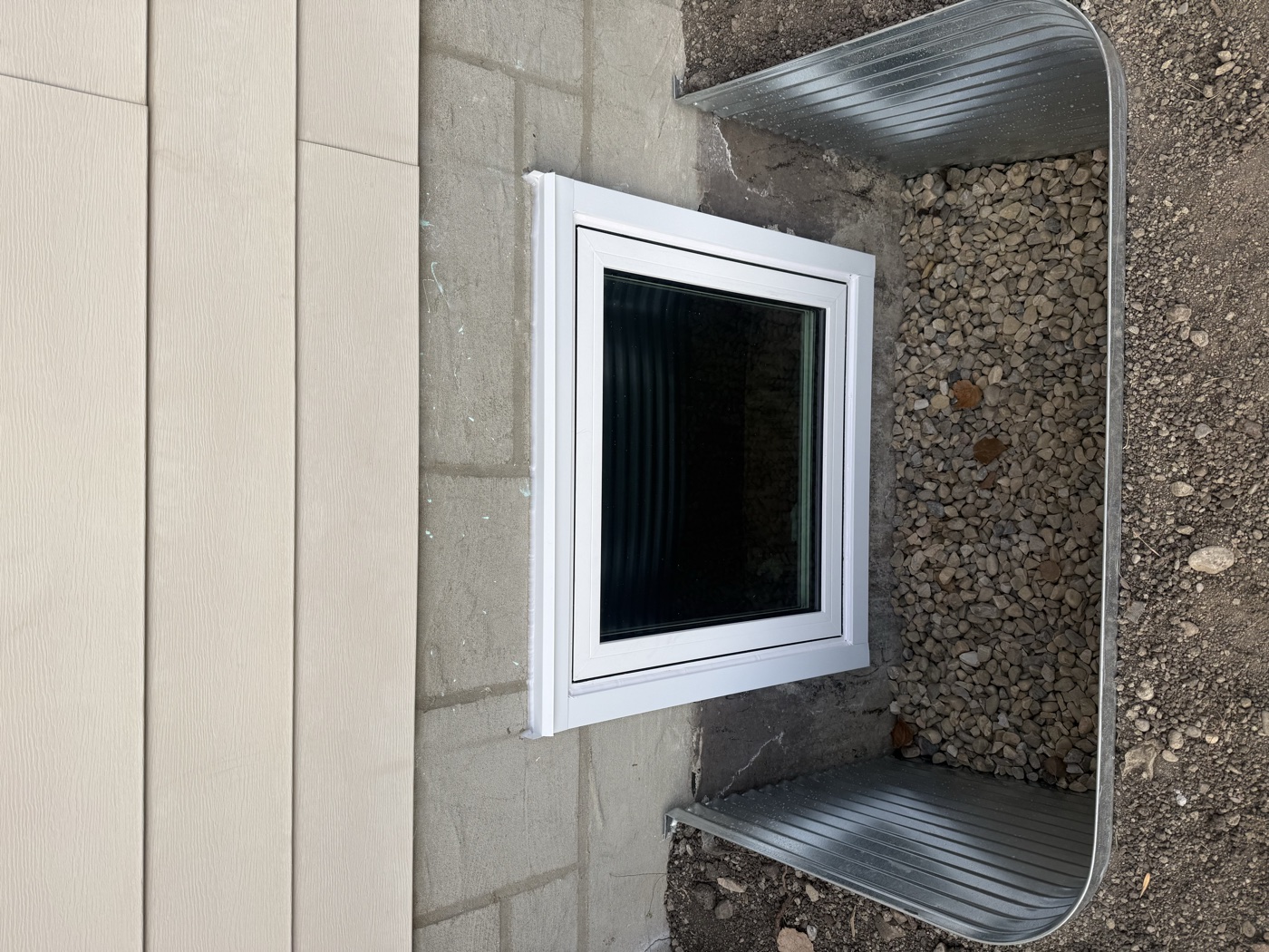 Completed egress casement window with galvanized well — Calgary